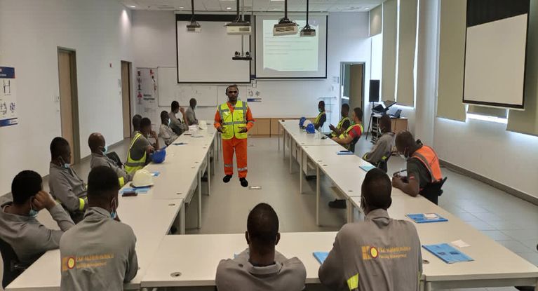 Manufacturing and warehouse workers engaged in hands-on workplace safety and first aid training in North Alabama.